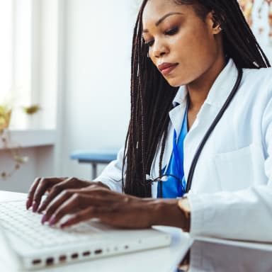 Image of a doctor working at a computer