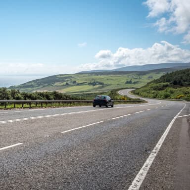 Image of a road with a car on it